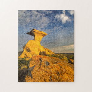 Geboetseerde Badlands-formatie in kort gras Legpuzzel