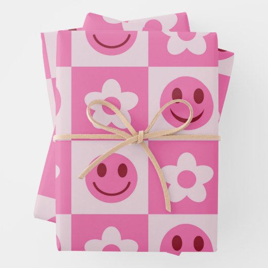 Gecontroleerde bloemen en vrolijke gezichten roze inpakpapier vel (In situ)