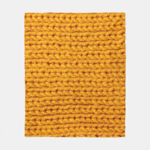 Geel patroon met achtergrondstructuur van gebreide fleece deken