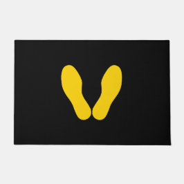 GEEL VOETPRINTS OP ZWART DEURMAT