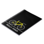 Gele bike met naam op zwart notitieboek (Linkerzijde)