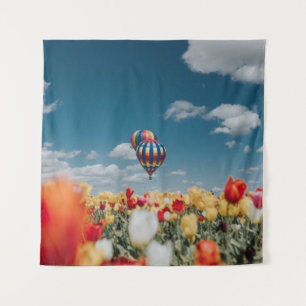 Gele en rode tulpbloemen onder heteluchtballon wandkleed