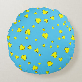 Gele harten op blauw rond kussen