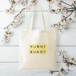Gele pastel "Hunny Bunny" Schattige Pasen Tote Bag<br><div class="desc">Draag de paasgeest overal met deze Gele Pastel "Hunny Bunny" Schattigee Paas Canvas tas! Met een charmant konijnenontwerp en zachte pastelgele tinten, is dit tas ideaal voor paaseitenjachten, voorjaarswinkelen of geschenken. Gemaakt van duurzame stof, het is herbruikbaar en stijlvol, waardoor het een milieuvriendelijk alternatief is voor het dragen van lekkernijen,...</div>