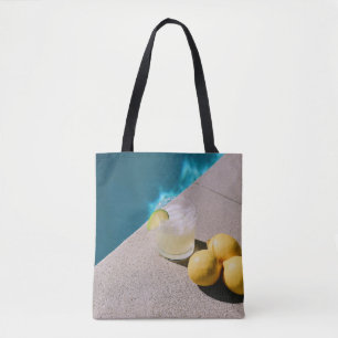 Gele ronde vruchten op grijze tafel tote bag