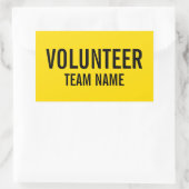 Gele vrijwilligersbadge met de naam van het team v rechthoekige sticker (Tas)