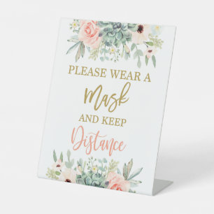 Gelieve een masker te draag reclamebord met voetstuk