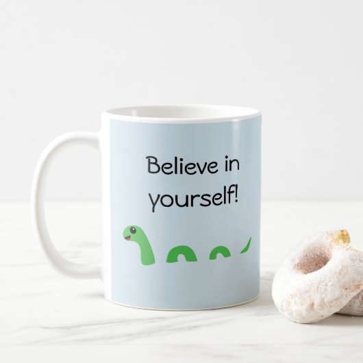 Geloof in jezelf Cartoon Loch Ness Monster Koffiemok (Met donut)