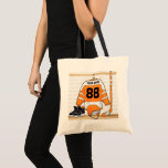 Gepersonaliseerd Oranje en wit ijs Hockey Jersey Tote Bag<br><div class="desc">Een ideaal cadeau voor een ijshockeyfan, een ijshockeyspeler of een ijshockeycoach, dit ontwerp is voorzien van een gepersonaliseerde ijshockeytruc in oranje en wit die in een sportkleedkamer hangt met een helm, ijshockeystick en een ijshockeystick. De truc kan volledig worden aangepast met het nummer en de naam van je keuze om...</div>