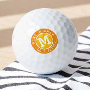 Gepersonaliseerde golfbal met geel-oranje monogram golfballen