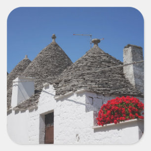 Geraniumbloemen en boomgaarden in Alberobello Vierkante Sticker