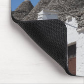 Geraniumbloemen en driehoekshuizen in Alberobello Muismat (Hoek)