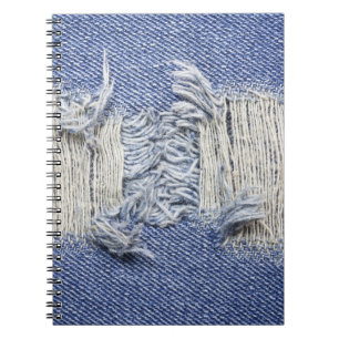 Gescheurd blauw denim: jeans textuur. notitieboek