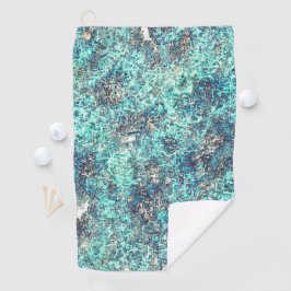 Gevoelig met gouden sinaasappel boven witgrijs golfhanddoek