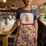 Gezellige Kerst Gingerbread Man Grammie's Keuken Schort<br><div class="desc">Dit feestelijke ontwerp is gemaakt met behulp van mijn zoete Scandinavische geïnspireerde koekjes in de vorm van een peperkoekman, een kerstboom en een ster omringd door citrus, gedroogde kruiden, groen en bessen die het gevoel oproepen van een warme cottage-keuken bij oma's gevuld met de geuren van vakantiebakken! De onderkant is...</div>