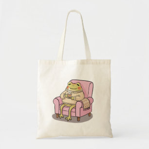 Gezellige kikker drinkt thee op de bank illustrati tote bag