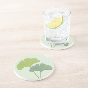 Ginkgo laat achtergrondkleuren achter zandsteen onderzetter