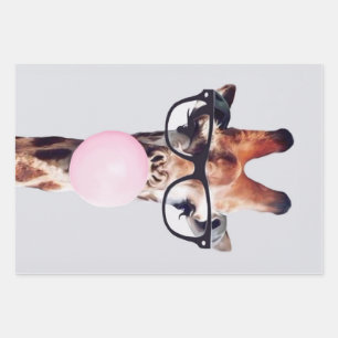 GIRAFFE MET GLAZEN DIE EEN PINKBUBBLEGUM BLOKKEN INPAKPAPIER VEL