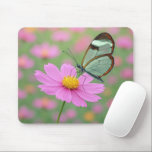 Glasswing Butterfly On a Cosmos Flower Muismat<br><div class="desc">A delicate glasswing butterfly with transparent wings gently settles on a vibrant pink cosmos flower, creating a dreamlike scene enhanced by a soft focus background</div>