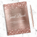 Glittery Roos Gold Foil 70th Birthday Guestbook Notitieboek<br><div class="desc">Creëer je eigen gastenboek voor haar 70ste verjaardagsfeest in dit lege notitieboek. Gulkleurig roos glitter op de boven- en onderrand van een roos goudkleurig,  zwart-roze faux digitale kunstachtergrond voor de folie van metalen. U kunt de lettertypekleur,  de stijl en de grootte aanpassen of indien nodig tekst toevoegen.</div>