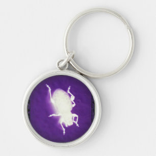 gloeiend insect met paars en zwart sleutelhanger