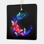 Gloeiende neon nachtvlinders op zwarte achtergrond keramisch ornament (Links)
