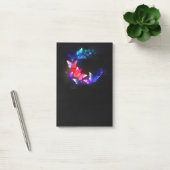 Gloeiende neon nachtvlinders op zwarte achtergrond post-it® notes (Kantoor)