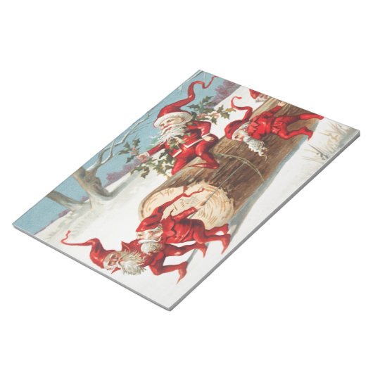 Gnomes dragging a cut tree trunk through the snow notitieblok (Schuin)