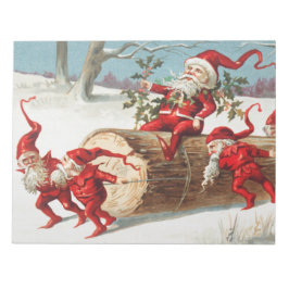 Gnomes dragging a cut tree trunk through the snow notitieblok