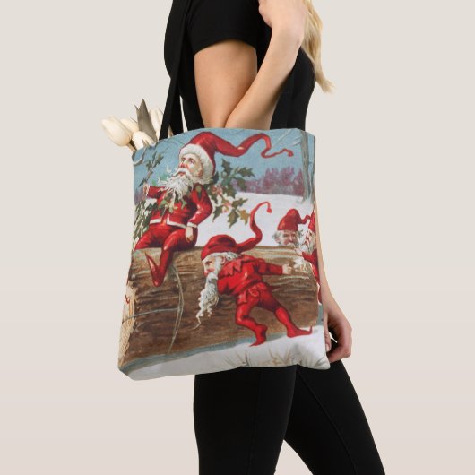 Gnomes dragging a cut tree trunk through the snow tote bag (Dichtbij)