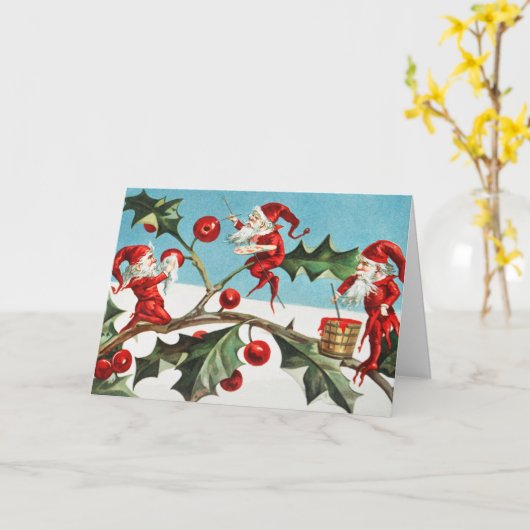 Gnomes painting holly berries in the snow kaart (Gele Bloem)
