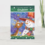 Godson, Cute Reindeer en Snowman Feestdagen Kaart<br><div class="desc">Voor Godson. Een schattige,  kleurrijke kerstkaart. De illustratie shows een zoet baby met grote open ogen en een leuke sneeuwman in een enorm pet die er goed uitziet,  neus aan neus,  aan elkaar. Ze zijn geplaatst tegen een blauwe waterverf hemel en de sneeuw valt om hen heen.</div>