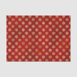 Gold kerstsnowflakes op rood tissuepapier