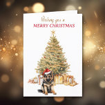 Gold Tree Duitse Herder Puppy Kerst Kaart<br><div class="desc">Op de voorzijde van deze kerstkaart draagt een schattige Duitse Herdershond een rood-witte kerstmuts en zit voor een kerstboom. De boom is gedecoreerd in goud, en bijpassende geschenkpakketten liggen eronder. In de rode en gouden tekst staat: "Ik wens u een vrolijk kerstfeest". In tekstvelden die u kunt aanpassen aan alles...</div>