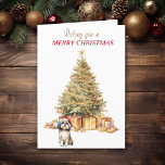 Gold Tree Shih Tzu Dog Christmas Kaart<br><div class="desc">Op de voorzijde van deze kerstkaart draagt een schattige Shih Tzu Dog een rode en witte kerstmuts en zit voor een kerstboom. De boom is gedecoreerd in goud, en bijpassende geschenkpakketten liggen eronder. In de rode en gouden tekst staat: "Ik wens u een vrolijk kerstfeest". In tekstvelden die u kunt...</div>