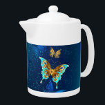 Golden Butterflies op een blauwe achtergrond Theepot<br><div class="desc">Vliegend goud,  juwelenvlinder op blauwe texturele achtergrond. Ontwerp met vlinders.</div>