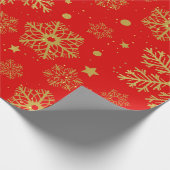 Golden sneeuwvlokken op rood cadeaupapier (Hoek)