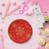 Golden sneeuwvlokken op rood papieren bordje (Feest)