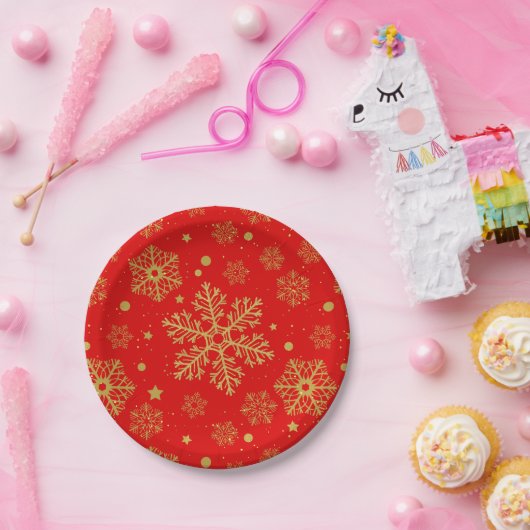 Golden sneeuwvlokken op rood papieren bordje (Feest)