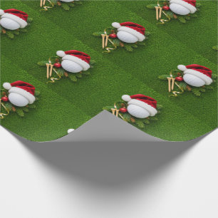 Golfbal draagt kerstmuts voor Kerstmis Cadeaupapier