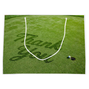 Golfbal naast hole op groen gras Bedankt  Groot Cadeauzakje