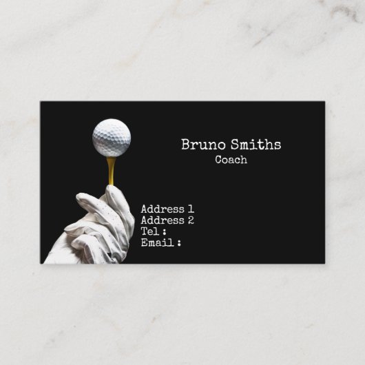 Golfbal op een speld naast een zwarte opening visitekaartje (Voorkant)