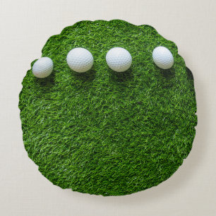 Golfballen liggen op groen gras rond kussen