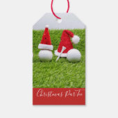 Golfballen met kerstmutsen zijn op groen cadeaulabel (Voorkant)