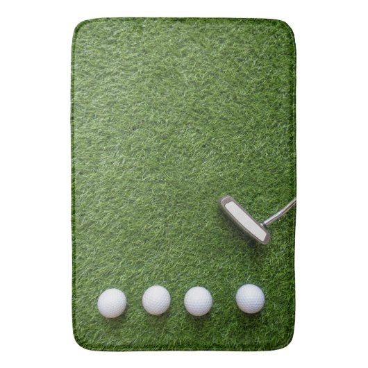 Golfballen zijn op groen grasbadmat badmat (Voorkant Verticaal)