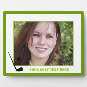 Golfclub en zwarte bal, groene gewoonte fotoplaat