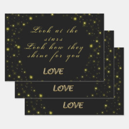 Goud en sparkles sterren op zwart inpakpapier vel