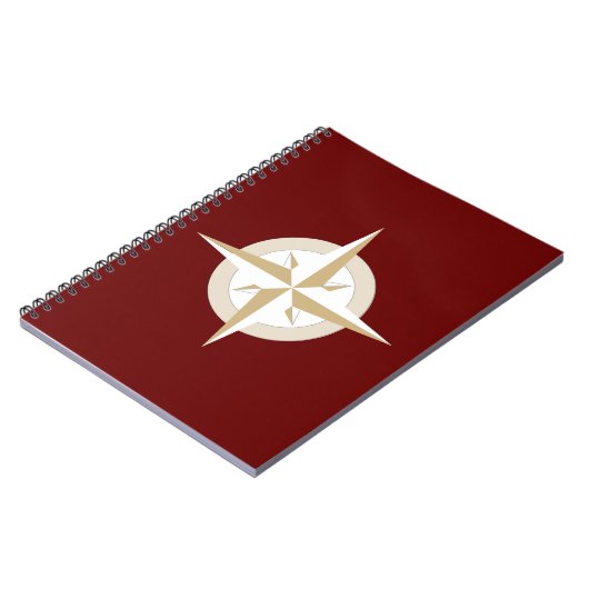 Goud en wit kompas op rood notitieboek (Linkerzijde)