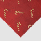 Goud kerstsnoepriet op rode lospagina tissuepapier (Detail)