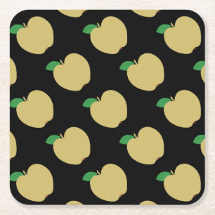 Gouden appel op zwart kartonnen onderzetters